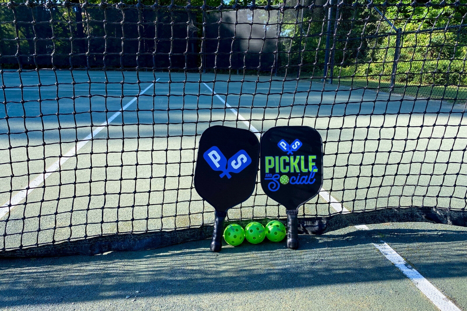 Pickle Ball Paddles & Balls On Court